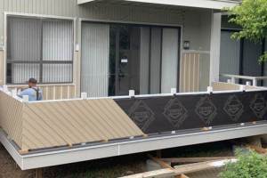 New smart panel siding being installed at balcony railing