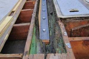 1/2" steel plate with 7/8" lags installed to strengthen weakened section of beam per engineers direction