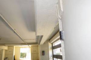 Drywall and stucco finished at garage ceiling after framing repairs