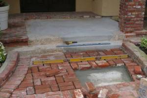 New concrete cured and mechanical banding removed - commencement of brick overlay install