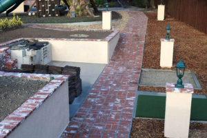 Masonry storage, vegetable garden, golf practice pads and lighting completed !
