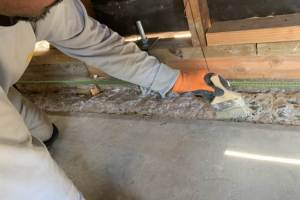Concrete adhesive being applied to strengthen bond of new to existing concrete