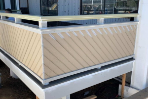 Composite trim, decay resistant treated upper caps (body guard) installed – exterior railing carpentry completed
