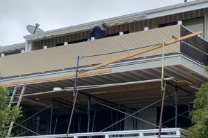 Composite siding installation at new balcony railing