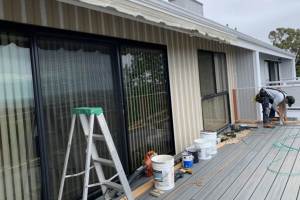 New composite siding installation at rear of unit adjacent to new balcony